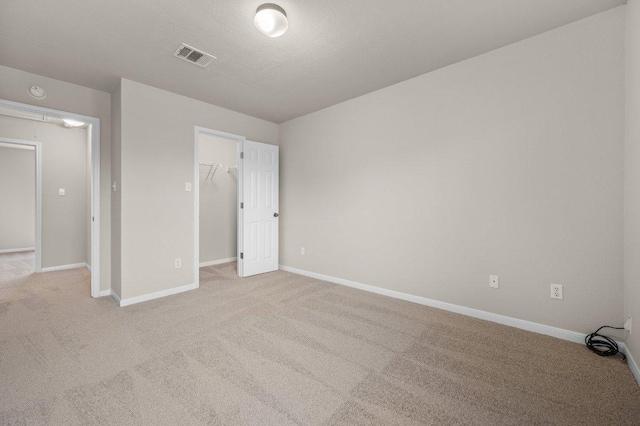 215 Gainer Dr, Hutto, TX 78634 - unfurnished bedroom with carpet flooring, baseboards, a spacious closet, and a closet