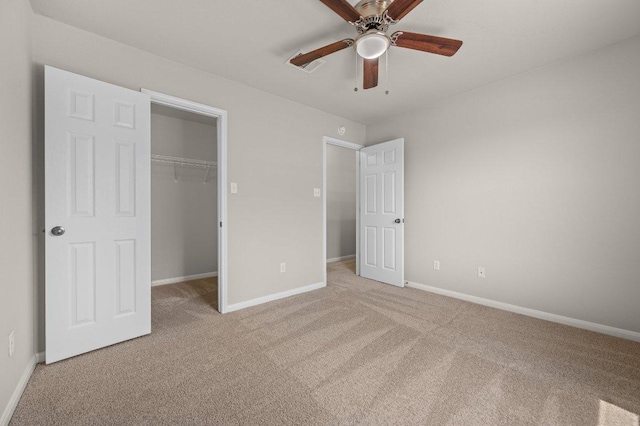 215 Gainer Dr, Hutto, TX 78634 - unfurnished bedroom featuring light carpet, a walk in closet, and baseboards