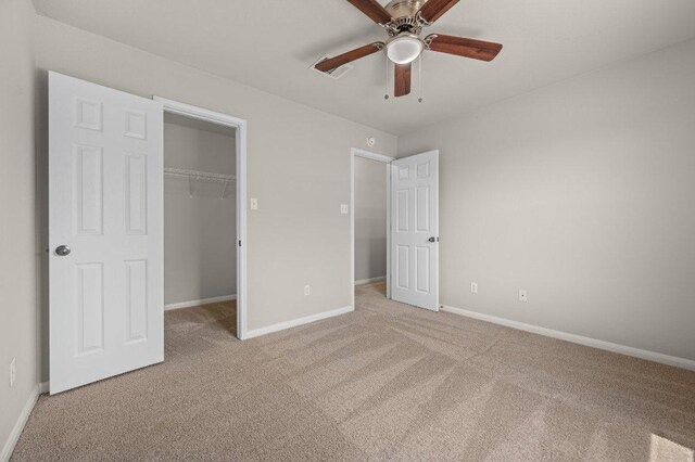 215 Gainer Dr, Hutto, TX 78634 - unfurnished bedroom with light colored carpet, a walk in closet, a closet, and ceiling fan