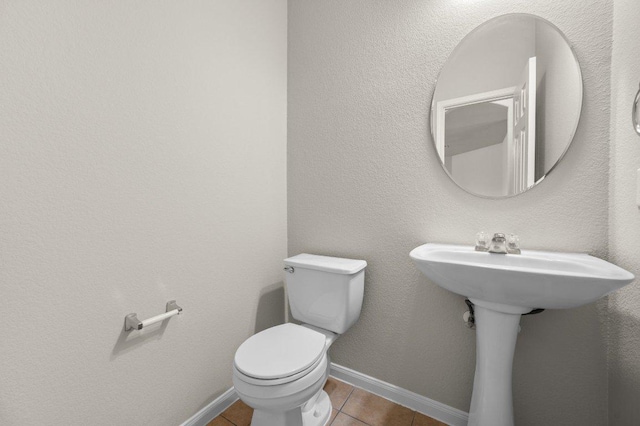 215 Gainer Dr, Hutto, TX 78634 - bathroom featuring tile patterned flooring, toilet, and baseboards