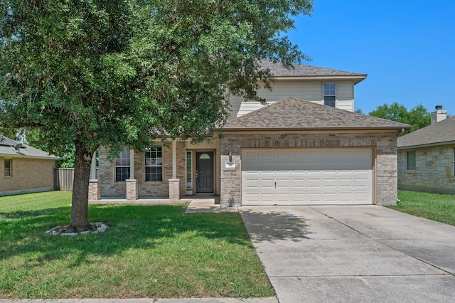 215 Gainer Dr, Hutto, TX 78634 - view of front facade with an attached garage, driveway, a front yard, a shingled roof, and brick siding