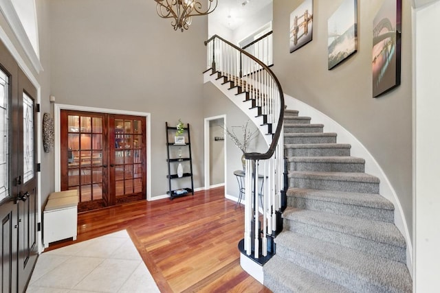 10408 Cassia Dr, Austin, TX 78759 - foyer with french doors, stairs, a high ceiling, baseboards, and a chandelier