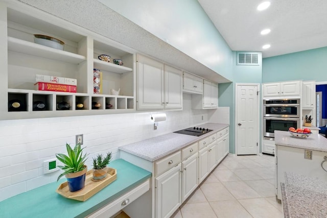 10408 Cassia Dr, Austin, TX 78759 - kitchen featuring stainless steel double oven, black electric stovetop, open shelves, white cabinetry, and light tile patterned floors