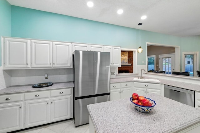 10408 Cassia Dr, Austin, TX 78759 - kitchen featuring stainless steel appliances, a sink, decorative backsplash, light countertops, and white cabinetry