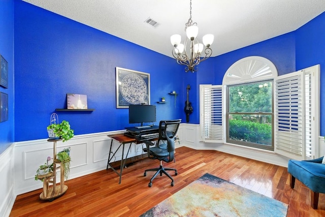 10408 Cassia Dr, Austin, TX 78759 - office area with a chandelier, wood finished floors, wainscoting, and a decorative wall