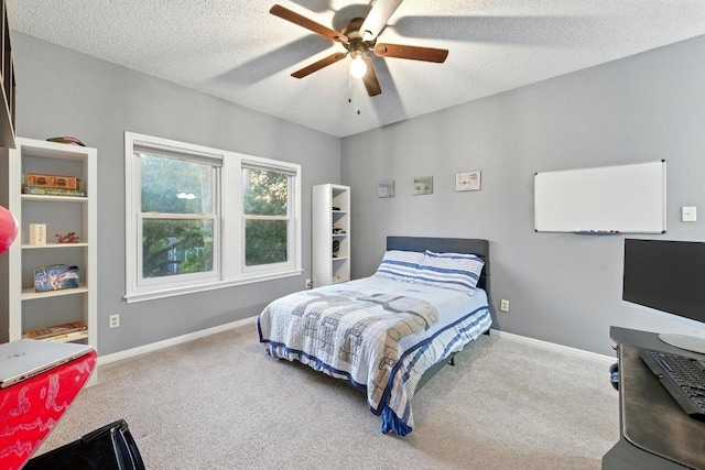 10408 Cassia Dr, Austin, TX 78759 - bedroom with carpet floors, baseboards, a textured ceiling, and a ceiling fan