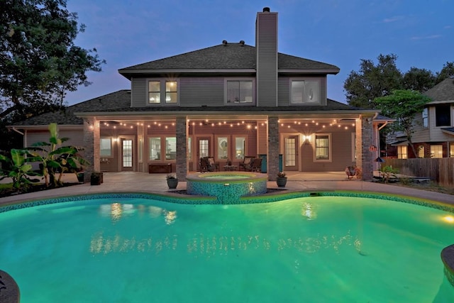 10408 Cassia Dr, Austin, TX 78759 - back of house with a patio area, a chimney, french doors, and a pool with connected hot tub