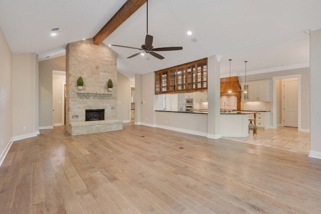 3602 Red Cedar Ct, Bryan, TX 77807 - unfurnished living room featuring a ceiling fan, a fireplace, light wood-type flooring, baseboards, and recessed lighting