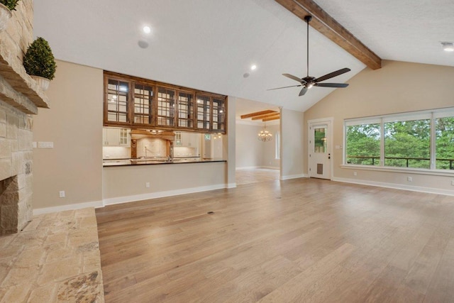 3602 Red Cedar Ct, Bryan, TX 77807 - unfurnished living room featuring ceiling fan, beam ceiling, light wood-type flooring, a chandelier, and a stone fireplace