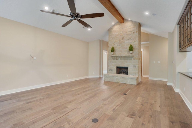 3602 Red Cedar Ct, Bryan, TX 77807 - unfurnished living room featuring a ceiling fan, light wood-style flooring, a stone fireplace, and baseboards