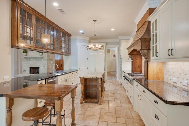 3602 Red Cedar Ct, Bryan, TX 77807 - kitchen featuring appliances with stainless steel finishes, a sink, stone tile floors, tasteful backsplash, and ornamental molding