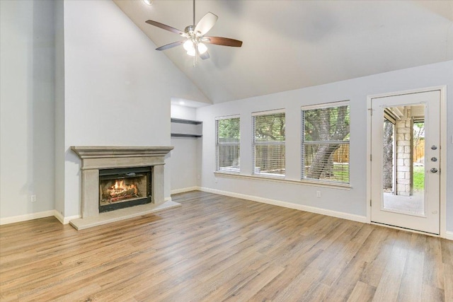 2709 Melba Pass, Cedar Park, TX 78613 - unfurnished living room featuring a ceiling fan, wood finished floors, a warm lit fireplace, baseboards, and high vaulted ceiling