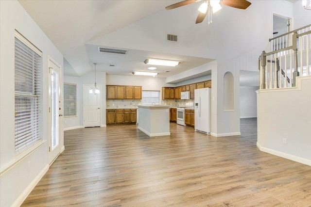 2709 Melba Pass, Cedar Park, TX 78613 - unfurnished living room featuring wood finished floors, a ceiling fan, baseboards, stairs, and vaulted ceiling