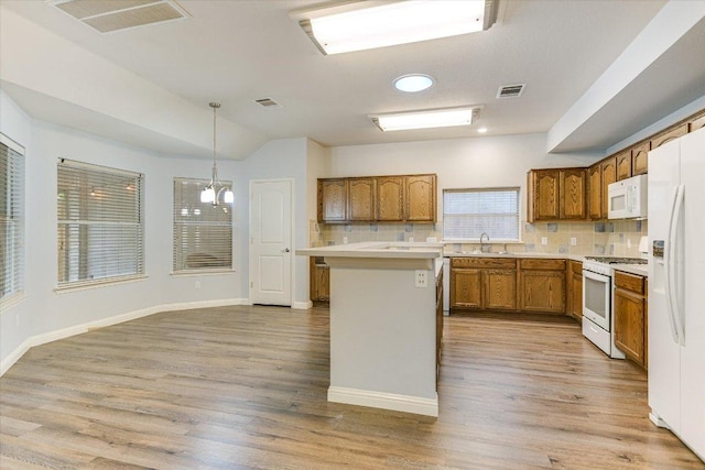 2709 Melba Pass, Cedar Park, TX 78613 - kitchen featuring white appliances, a sink, brown cabinets, backsplash, and light countertops