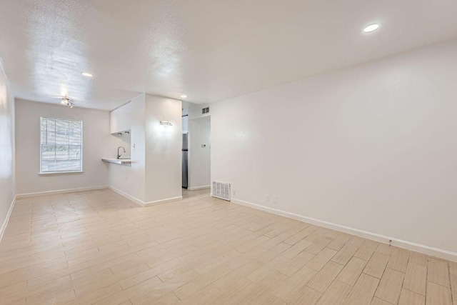 300 Crockett St Unit 115, Austin, TX 78704 - unfurnished room with recessed lighting, baseboards, and light wood-style flooring