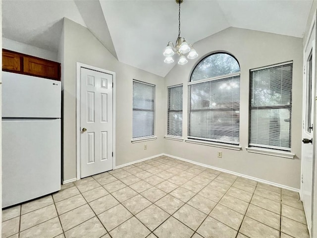 1933 Lisa Ln, San Marcos, TX 78666 - unfurnished dining area featuring lofted ceiling, a chandelier, light tile patterned floors, and baseboards