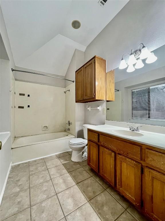 1933 Lisa Ln, San Marcos, TX 78666 - bathroom with lofted ceiling, shower / tub combination, vanity, tile patterned flooring, and toilet