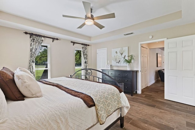 3701 Arrowhead Cir, Round Rock, TX 78681 - bedroom featuring wood finished floors, a raised ceiling, and ceiling fan