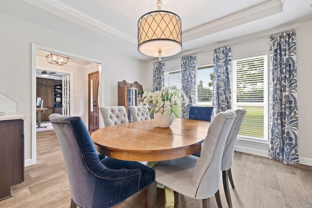 3701 Arrowhead Cir, Round Rock, TX 78681 - dining space with a raised ceiling, a chandelier, crown molding, and light wood-type flooring