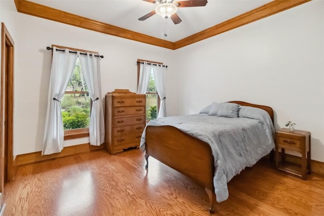 402 Lander Ln, Dripping Springs, TX 78620 - bedroom with crown molding, light wood-style flooring, baseboards, and ceiling fan