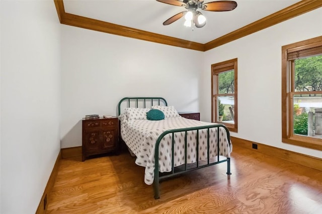 402 Lander Ln, Dripping Springs, TX 78620 - bedroom featuring crown molding, light wood-type flooring, baseboards, and a ceiling fan