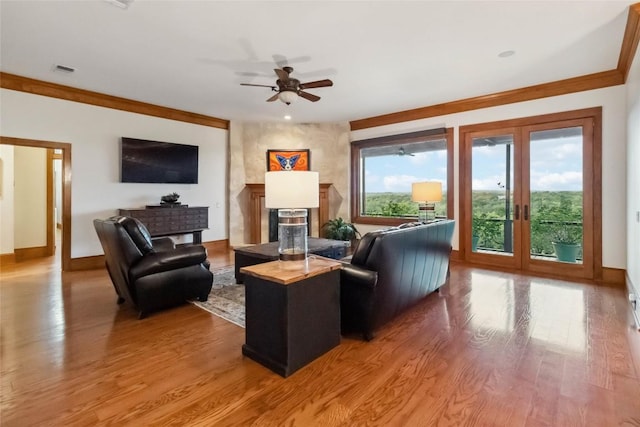 402 Lander Ln, Dripping Springs, TX 78620 - living room with baseboards, wood finished floors, ceiling fan, a fireplace, and crown molding