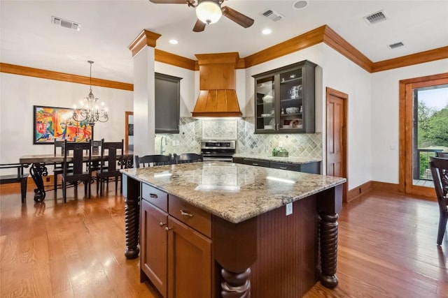 402 Lander Ln, Dripping Springs, TX 78620 - kitchen featuring electric stove, custom exhaust hood, light wood-style flooring, ornamental molding, and backsplash
