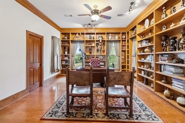 402 Lander Ln, Dripping Springs, TX 78620 - home office featuring ceiling fan, baseboards, built in shelves, wood finished floors, and ornamental molding