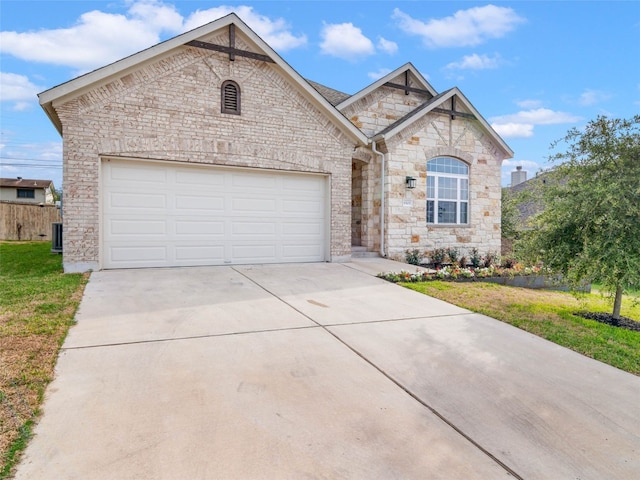 8505 Moccasin Path, Austin, TX 78736 - french country home featuring stone siding, driveway, an attached garage, and cooling unit