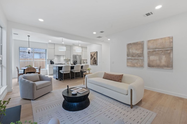 5209 Concho Creek Bnd, Austin, TX 78735 - living area with light wood finished floors, recessed lighting, and baseboards