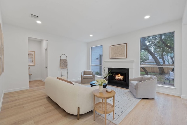 5209 Concho Creek Bnd, Austin, TX 78735 - living area featuring a fireplace with flush hearth, light wood-style flooring, baseboards, and recessed lighting