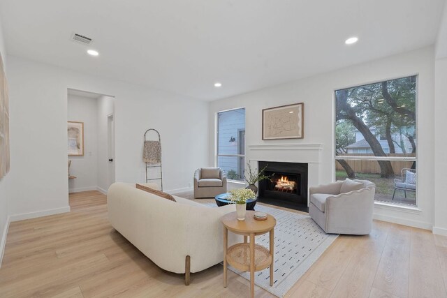 5209 Concho Creek Bnd, Austin, TX 78735 - living room featuring a fireplace with flush hearth, light wood-type flooring, and recessed lighting