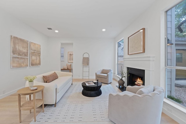 5209 Concho Creek Bnd, Austin, TX 78735 - living room featuring a lit fireplace, light wood-style flooring, recessed lighting, and baseboards