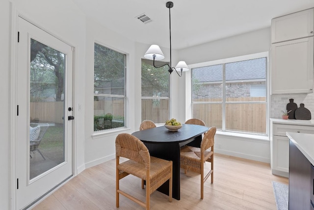 5209 Concho Creek Bnd, Austin, TX 78735 - dining space featuring light wood-style floors, plenty of natural light, and baseboards