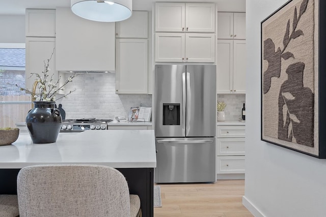 5209 Concho Creek Bnd, Austin, TX 78735 - kitchen featuring stainless steel fridge with ice dispenser, light wood-type flooring, light countertops, and white cabinetry