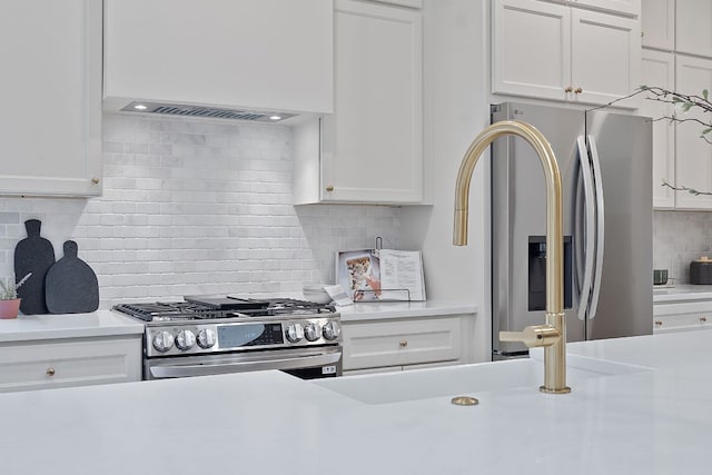 5209 Concho Creek Bnd, Austin, TX 78735 - kitchen featuring appliances with stainless steel finishes, decorative backsplash, custom exhaust hood, light countertops, and white cabinetry