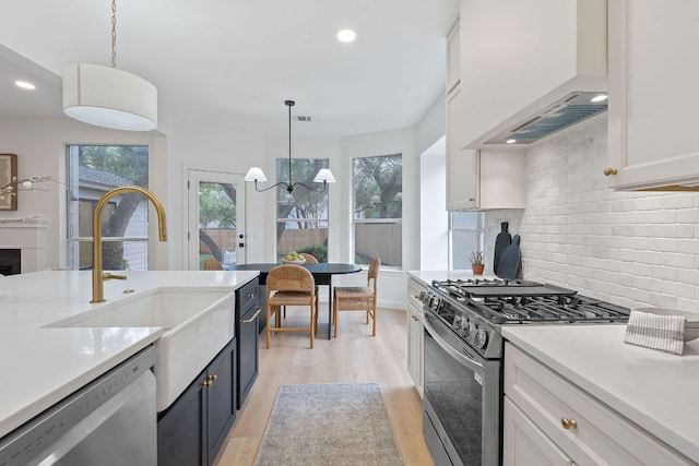 5209 Concho Creek Bnd, Austin, TX 78735 - kitchen featuring stainless steel appliances, custom exhaust hood, tasteful backsplash, light wood-type flooring, and light countertops