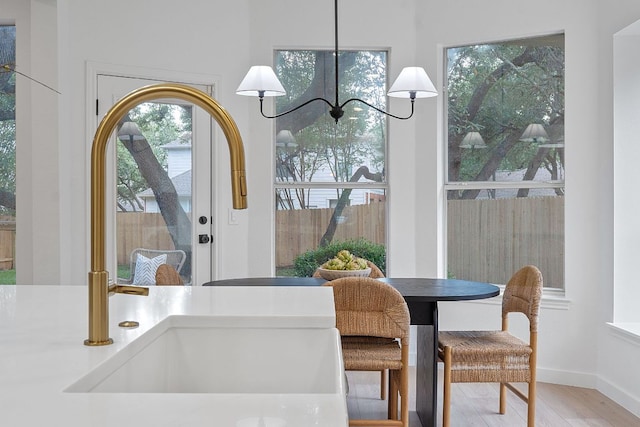 5209 Concho Creek Bnd, Austin, TX 78735 - dining area with wood finished floors, a chandelier, and baseboards