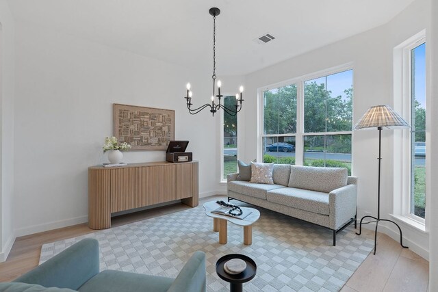 5209 Concho Creek Bnd, Austin, TX 78735 - living area featuring plenty of natural light, a chandelier, and light wood-style flooring