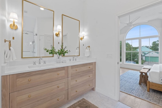 5209 Concho Creek Bnd, Austin, TX 78735 - bathroom with double vanity, a shower with door, baseboards, ceiling fan, and ensuite bath
