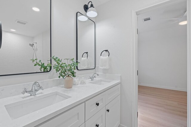 5209 Concho Creek Bnd, Austin, TX 78735 - full bath with double vanity, wood finished floors, and recessed lighting