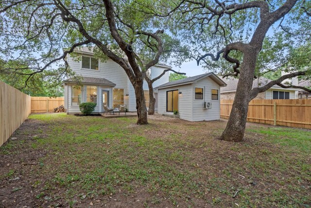 5209 Concho Creek Bnd, Austin, TX 78735 - rear view of property with a fenced backyard and an outdoor structure