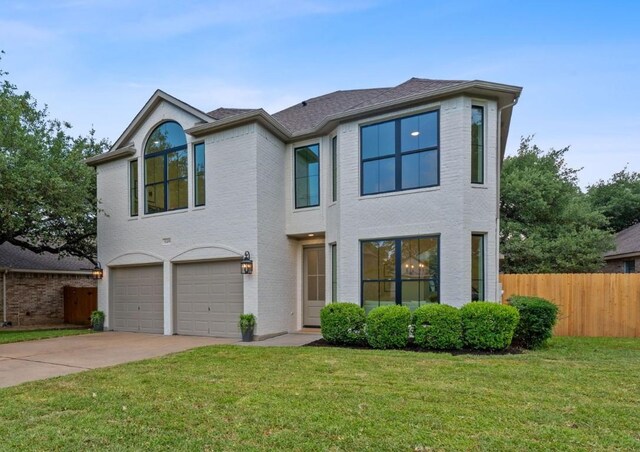 5209 Concho Creek Bnd, Austin, TX 78735 - view of front facade with a garage, concrete driveway, and brick siding