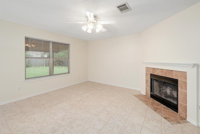 2202 Clayton Way, Cedar Park, TX 78613 - unfurnished living room featuring a ceiling fan, a tile fireplace, a textured ceiling, and baseboards