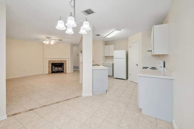 2202 Clayton Way, Cedar Park, TX 78613 - kitchen featuring freestanding refrigerator, a ceiling fan, stove, light countertops, and a chandelier