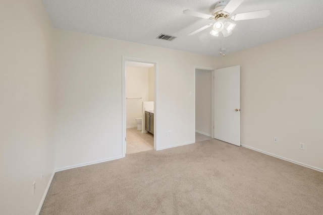 2202 Clayton Way, Cedar Park, TX 78613 - unfurnished bedroom with light colored carpet, a textured ceiling, connected bathroom, baseboards, and ceiling fan