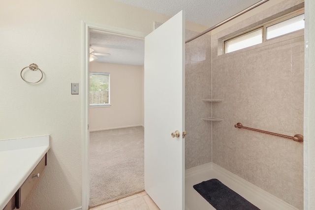 2202 Clayton Way, Cedar Park, TX 78613 - bathroom with tiled shower, a textured ceiling, and vanity