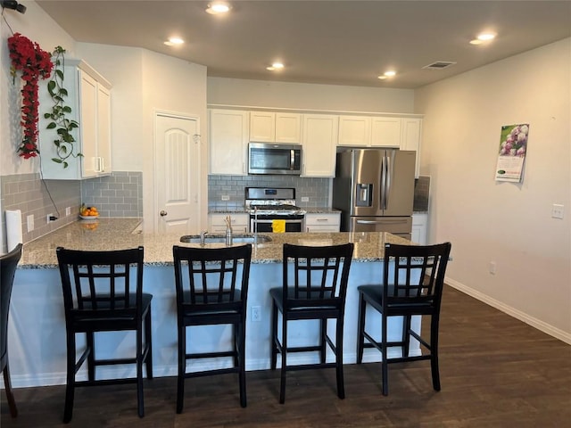 201 Abby Rd, Georgetown, TX 78626 - kitchen featuring appliances with stainless steel finishes, a sink, a peninsula, white cabinets, and recessed lighting