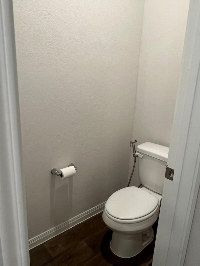 201 Abby Rd, Georgetown, TX 78626 - bathroom featuring wood finished floors, baseboards, and toilet