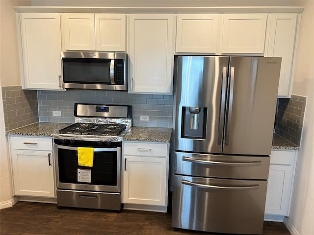 201 Abby Rd, Georgetown, TX 78626 - kitchen featuring appliances with stainless steel finishes, dark stone counters, and white cabinets